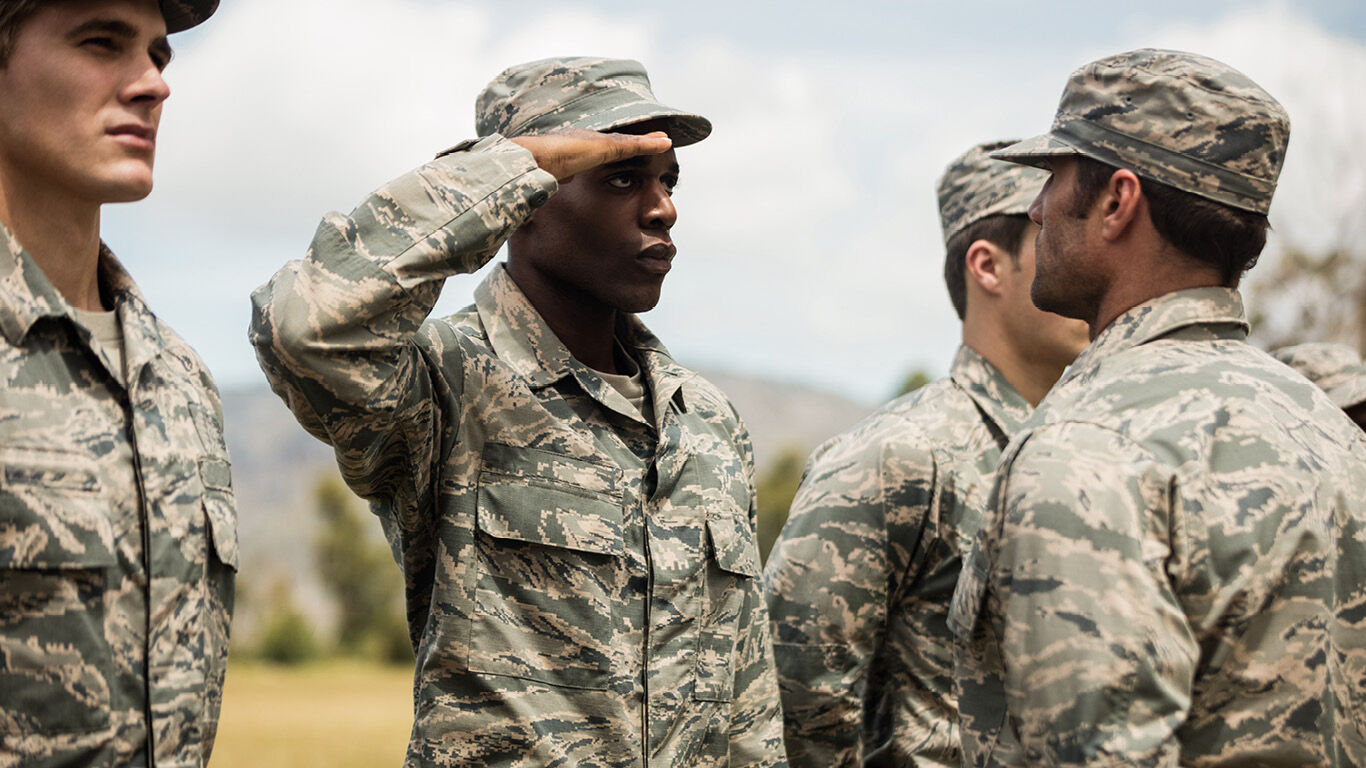 Miliary members saluting stock photo.