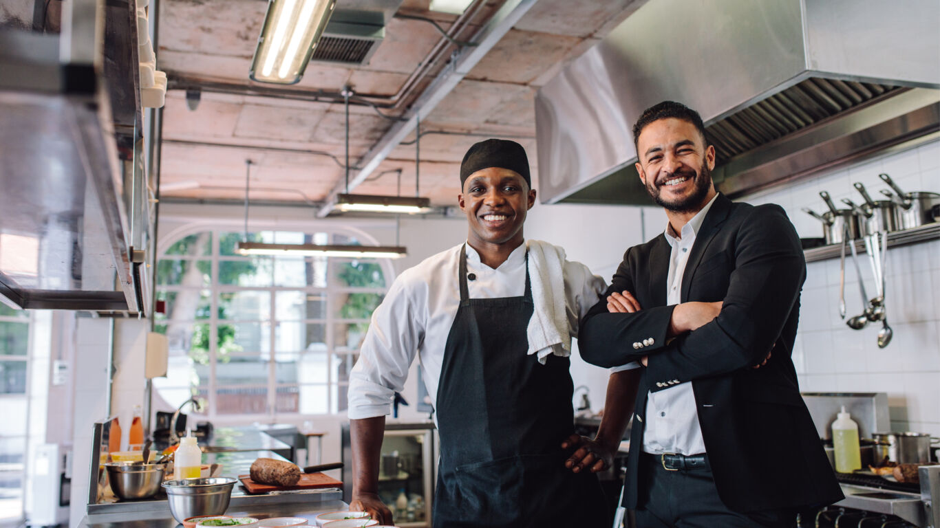 Front desk worker checking couple in stock image 