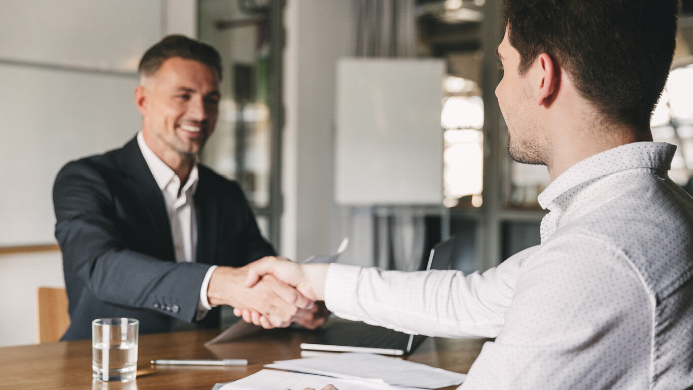 Interviewer and job applicant shaking hands